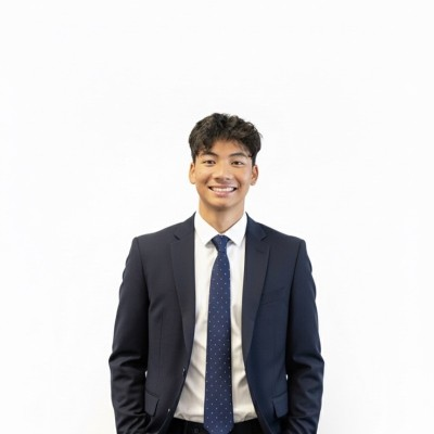Aung B. Mhn smiling in a suit and tie